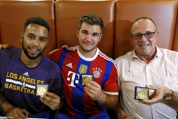 Heros: "Anthony Sadler, from Pittsburg, California, Aleck Sharlatos from Roseburg, Oregon, and Chris Norman, a British man living in France thwarted the attacker while on the train. They are pictured with medals they received for bravery  Daily Mail